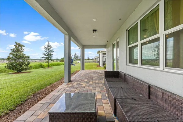 a living room with furniture and a dining table with kitchen view