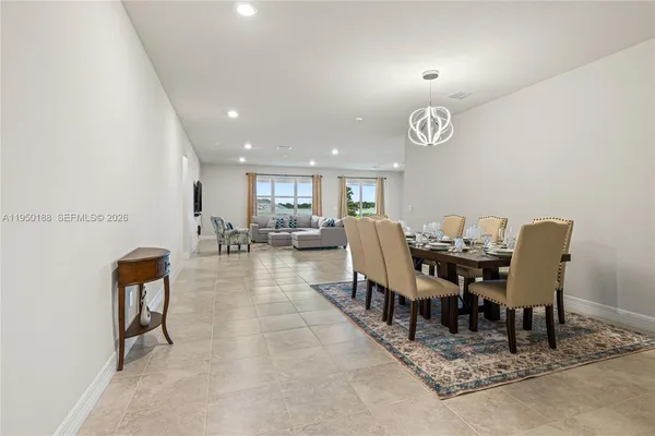 a kitchen with stainless steel appliances kitchen island granite countertop a sink a stove and cabinets