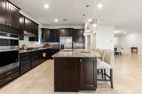 a living room with furniture and kitchen view