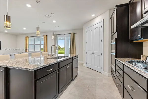 a living room with furniture and a dining table with kitchen view