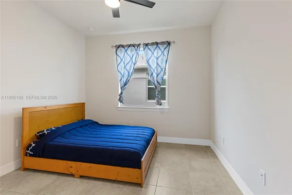 a bedroom with a bed and a mirror