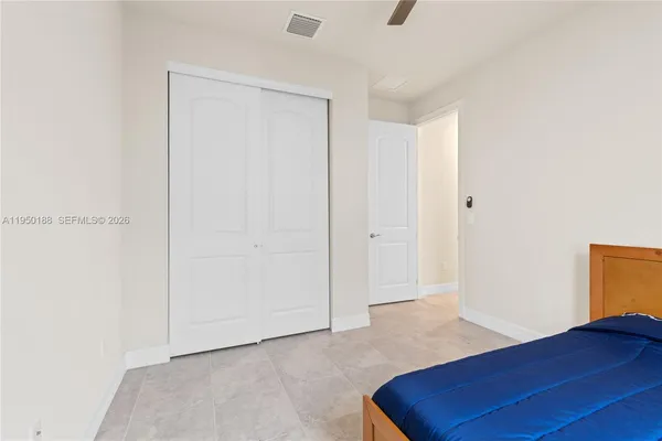 a bathroom with a granite countertop sink toilet and mirror