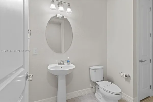 a spacious bedroom with a bed and a flat screen tv