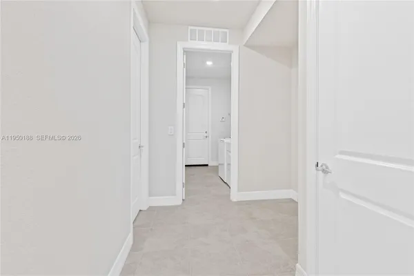 a spacious bedroom with a bed and a flat screen television