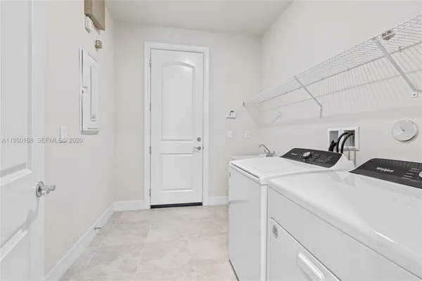 a spacious bedroom with a bed and a flat screen television