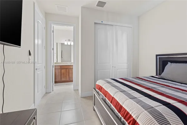 a bathroom with a granite countertop sink a toilet a mirror and bathtub