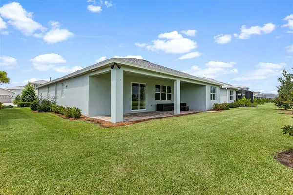 a view of a house with a backyard