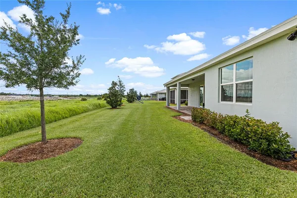 a front view of a house with outdoor seating