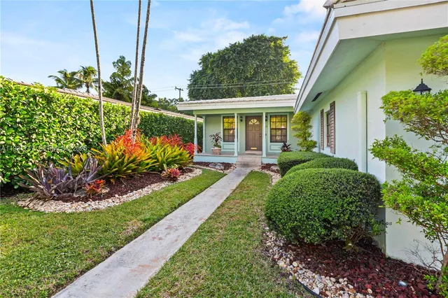a front view of a house with a yard table and chairs