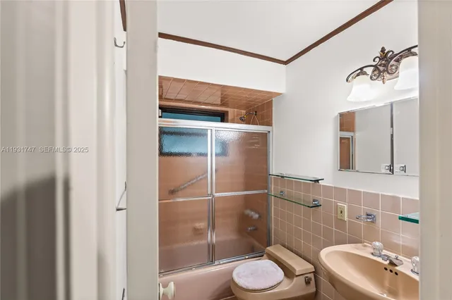 a bathroom with a toilet a sink and shower