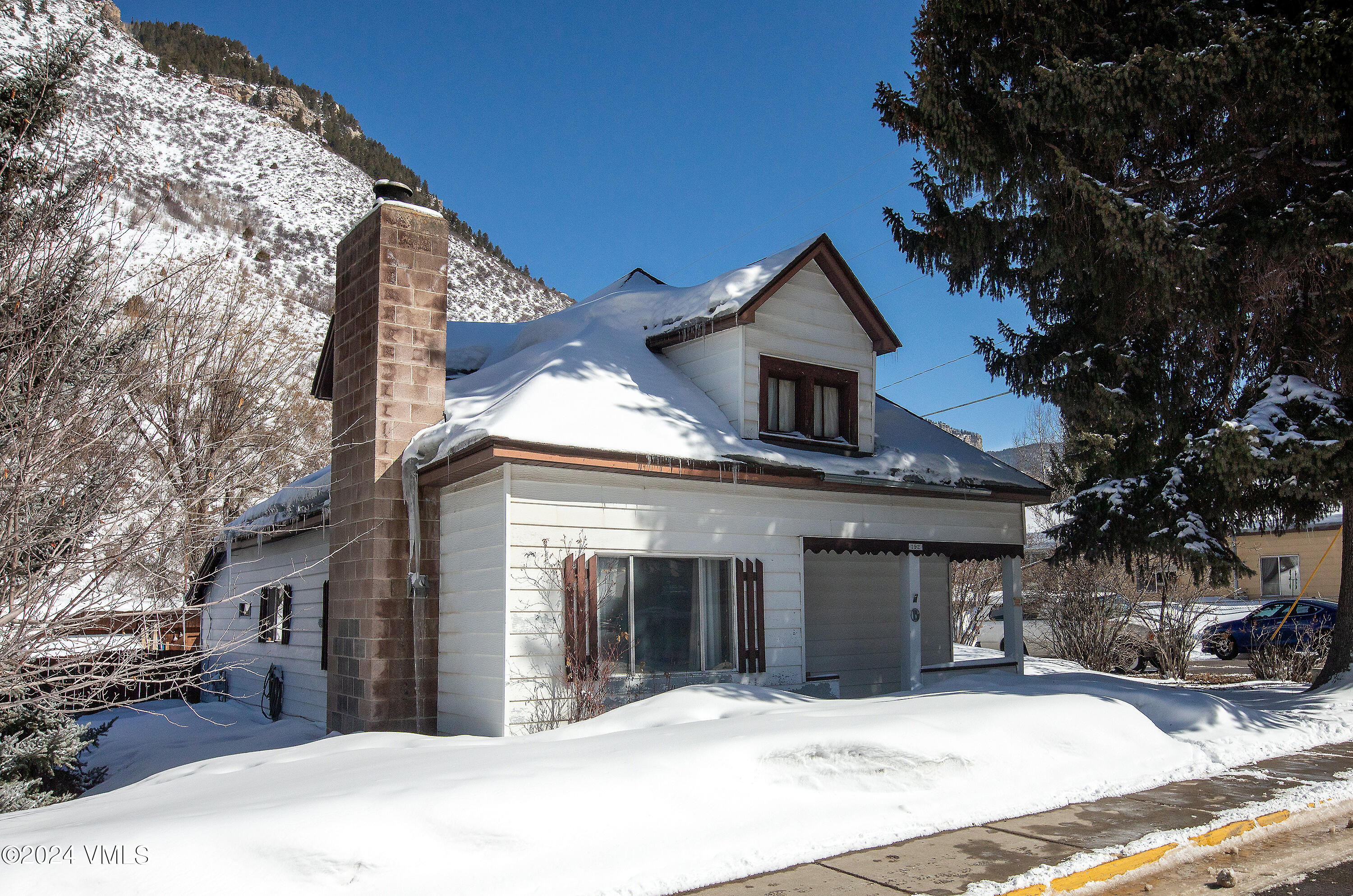 192 Main Street Minturn, CO 81645 - Photo 11 of 17 a front view of a house with a yard covered with snow