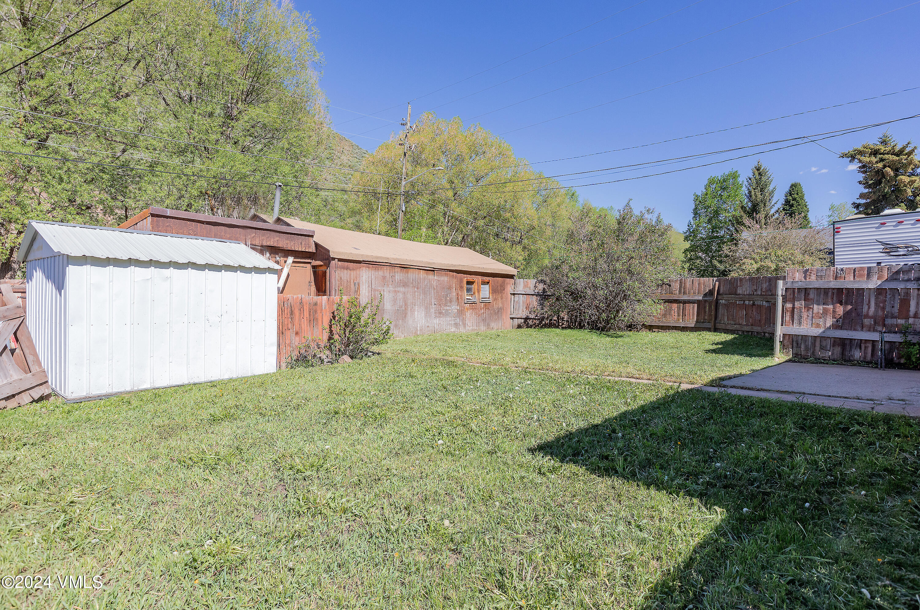 192 Main Street Minturn, CO 81645 - Photo 7 of 17 a backyard of a house with plants and large trees