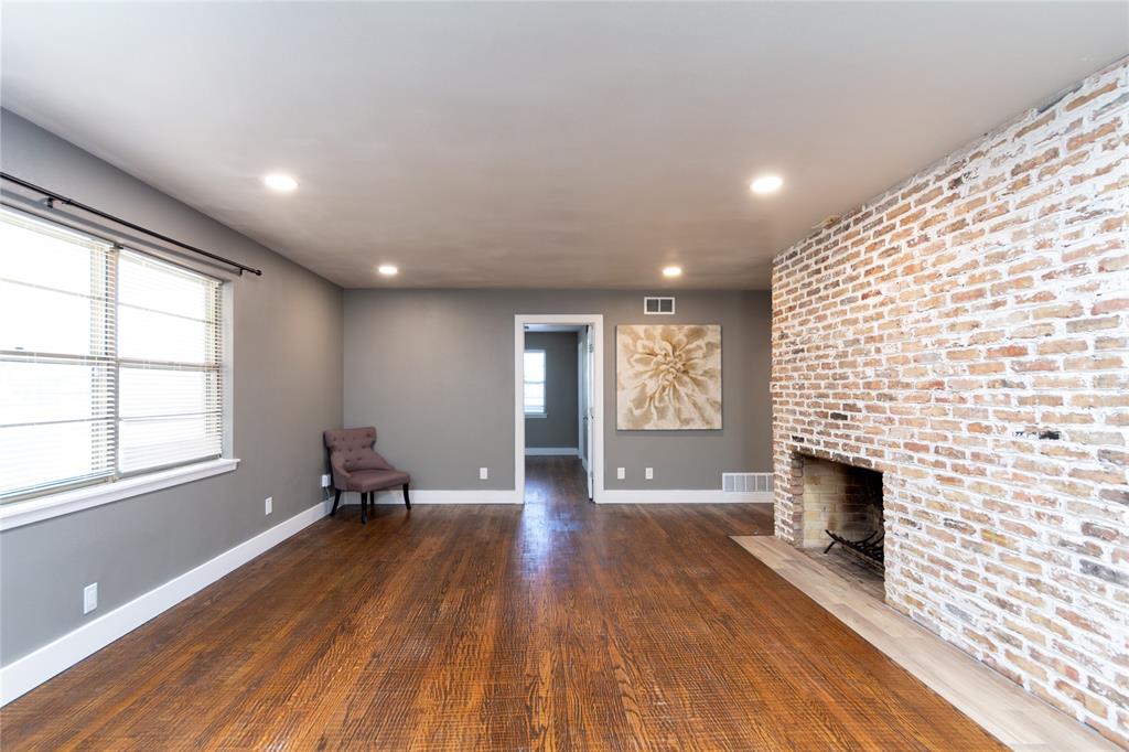 3217 Cedarcroft Lane Dallas, TX 75233 - Photo 5 of 27 Brick accent wall and fireplace
