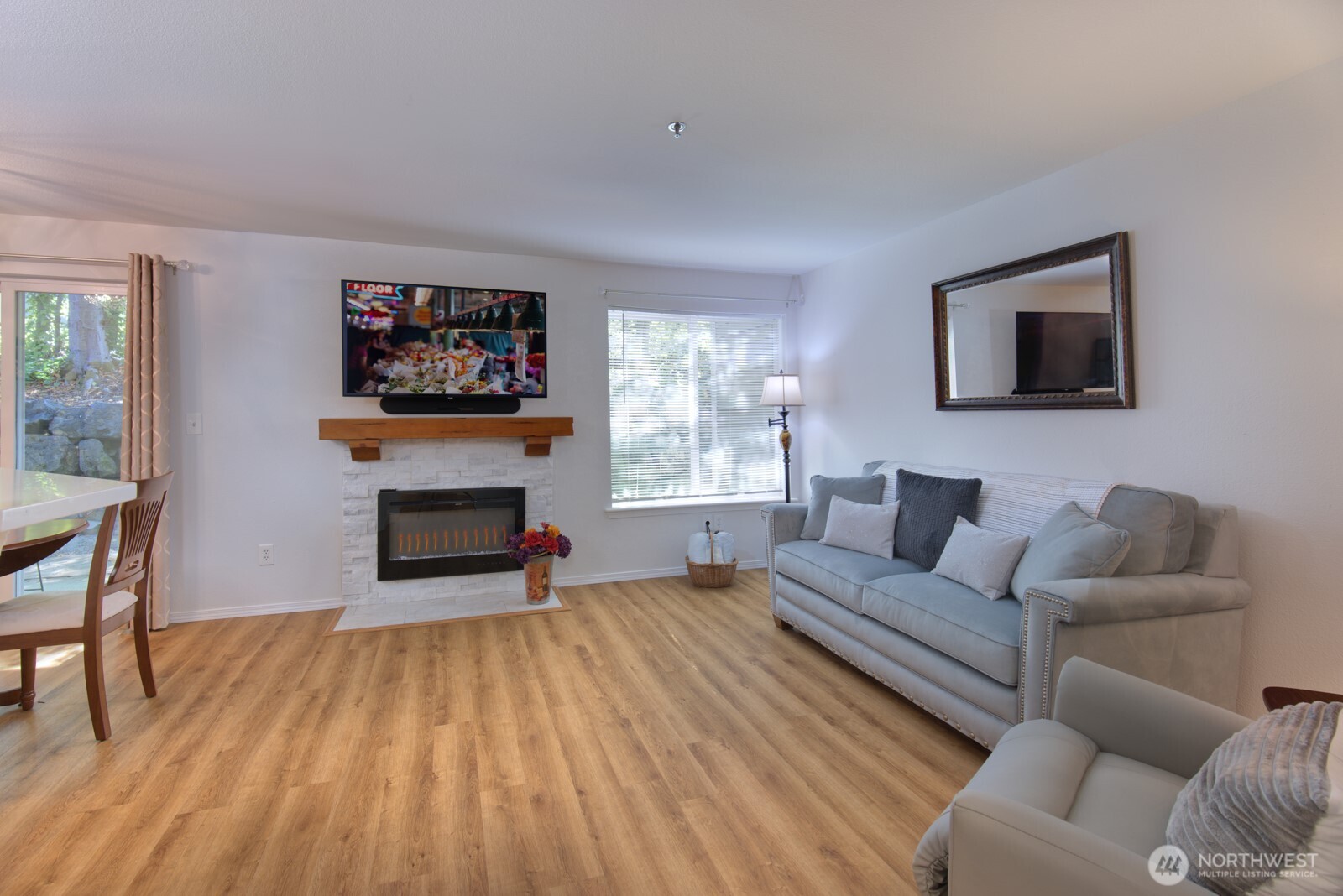 11527 Highway 99, Unit C102 Everett, WA 98204 - Photo 1 of 15 a living room with furniture and a flat screen tv