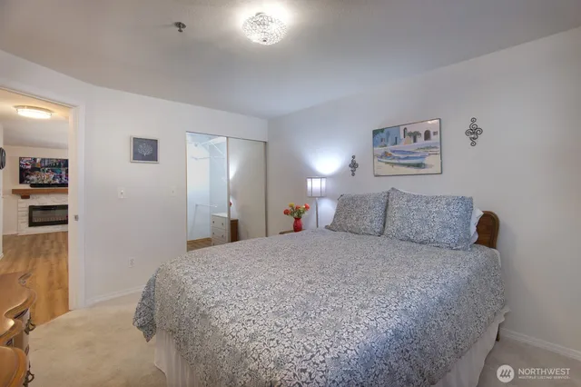 a large bedroom with a bed and a cabinets