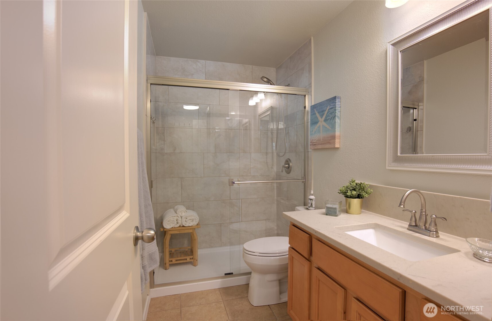 11527 Highway 99, Unit C102 Everett, WA 98204 - Photo 10 of 15 a bathroom with a granite countertop sink toilet and shower