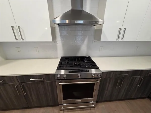 a kitchen with a sink and wooden floor