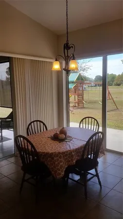 a dining room with furniture and window