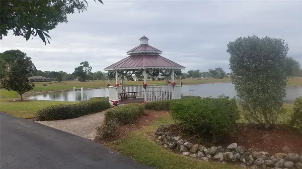 a front view of a house with a yard and lake view