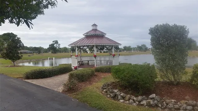 a front view of a house with a yard and lake view