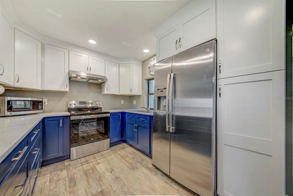 4266 Deleon Drive Hernando Beach, FL 34607 - Photo 14 of 65 a kitchen with stainless steel appliances granite countertop a refrigerator and a stove