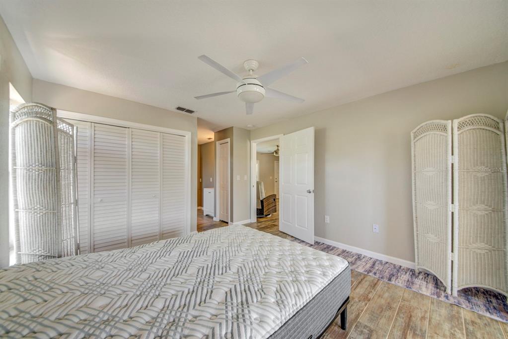 4266 Deleon Drive Hernando Beach, FL 34607 - Photo 22 of 65 a bedroom with a bed and a chandelier