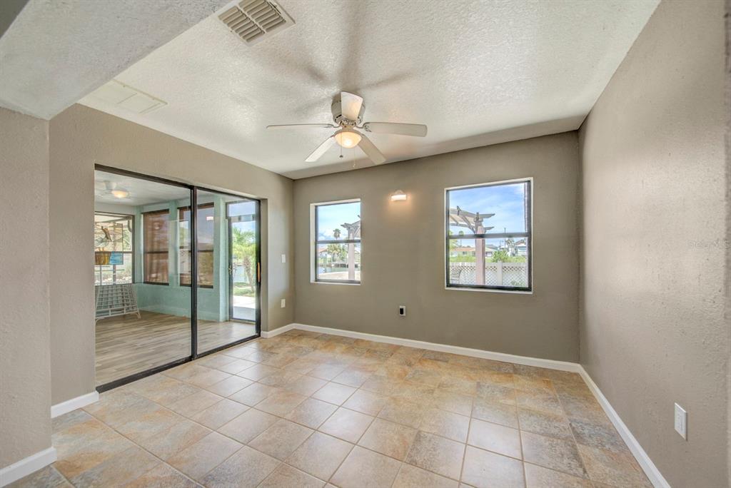 4266 Deleon Drive Hernando Beach, FL 34607 - Photo 23 of 65 a view of an empty room with window and chandelier fan