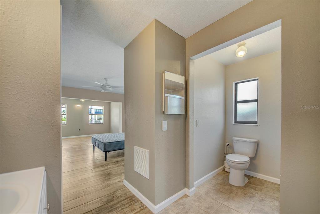 4266 Deleon Drive Hernando Beach, FL 34607 - Photo 27 of 65 a bathroom with a toilet a sink and mirror
