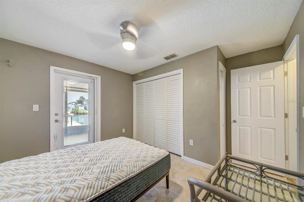 4266 Deleon Drive Hernando Beach, FL 34607 - Photo 34 of 65 a bedroom with a bed and a window