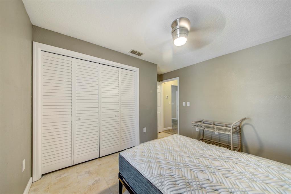 4266 Deleon Drive Hernando Beach, FL 34607 - Photo 35 of 65 a bedroom with a bed and a window