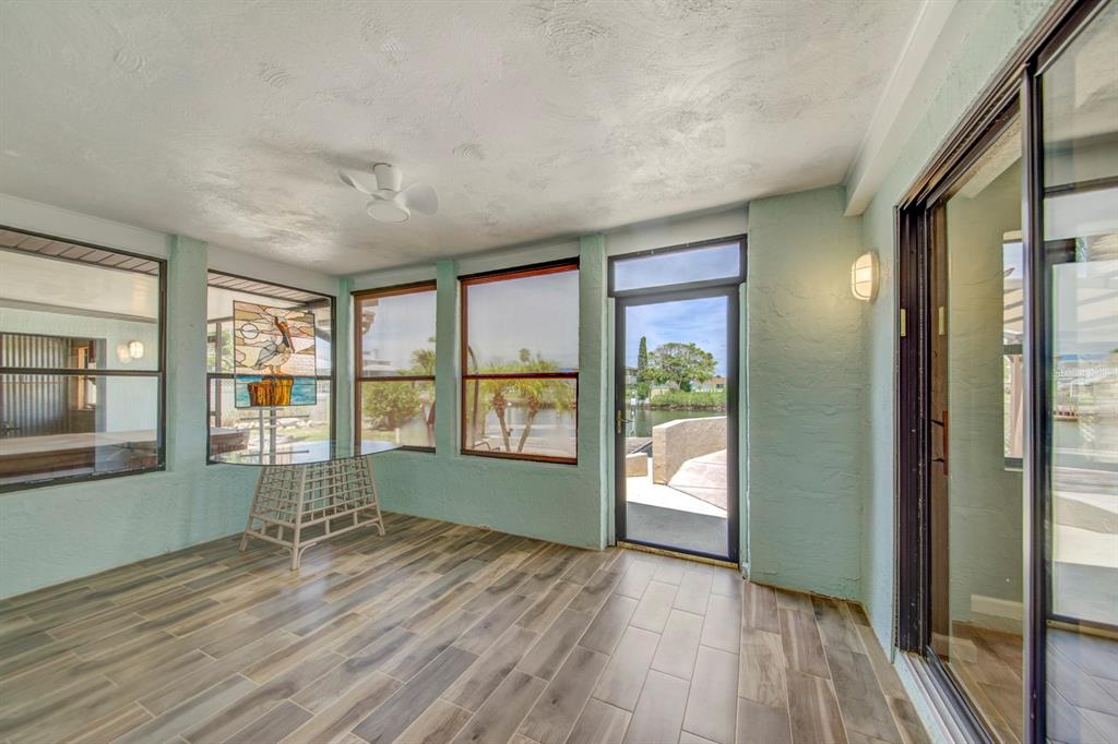 4266 Deleon Drive Hernando Beach, FL 34607 - Photo 36 of 65 a view of empty room with wooden floor and fan