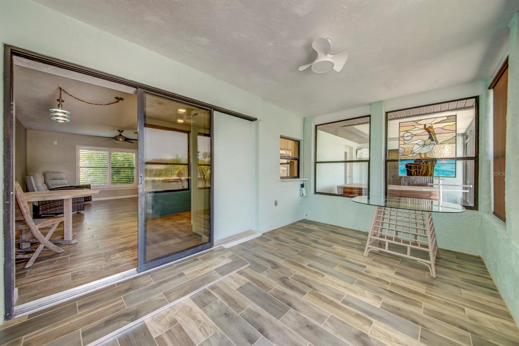 4266 Deleon Drive Hernando Beach, FL 34607 - Photo 37 of 65 a view of empty room with wooden floor and floor to ceiling window