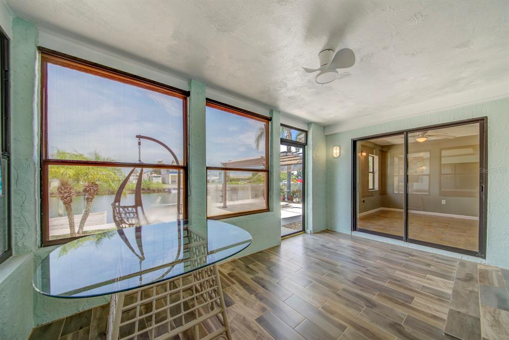 4266 Deleon Drive Hernando Beach, FL 34607 - Photo 38 of 65 a view of an empty room with wooden floor and a window