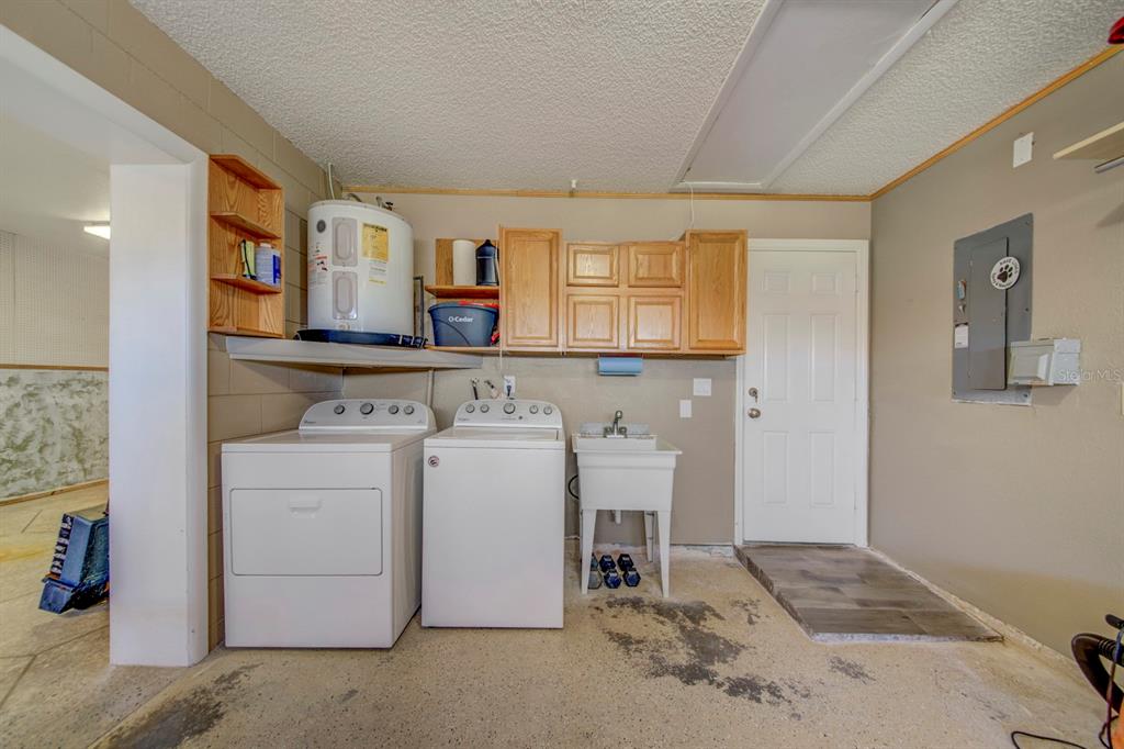 4266 Deleon Drive Hernando Beach, FL 34607 - Photo 42 of 65 a utility room with dryer and washer