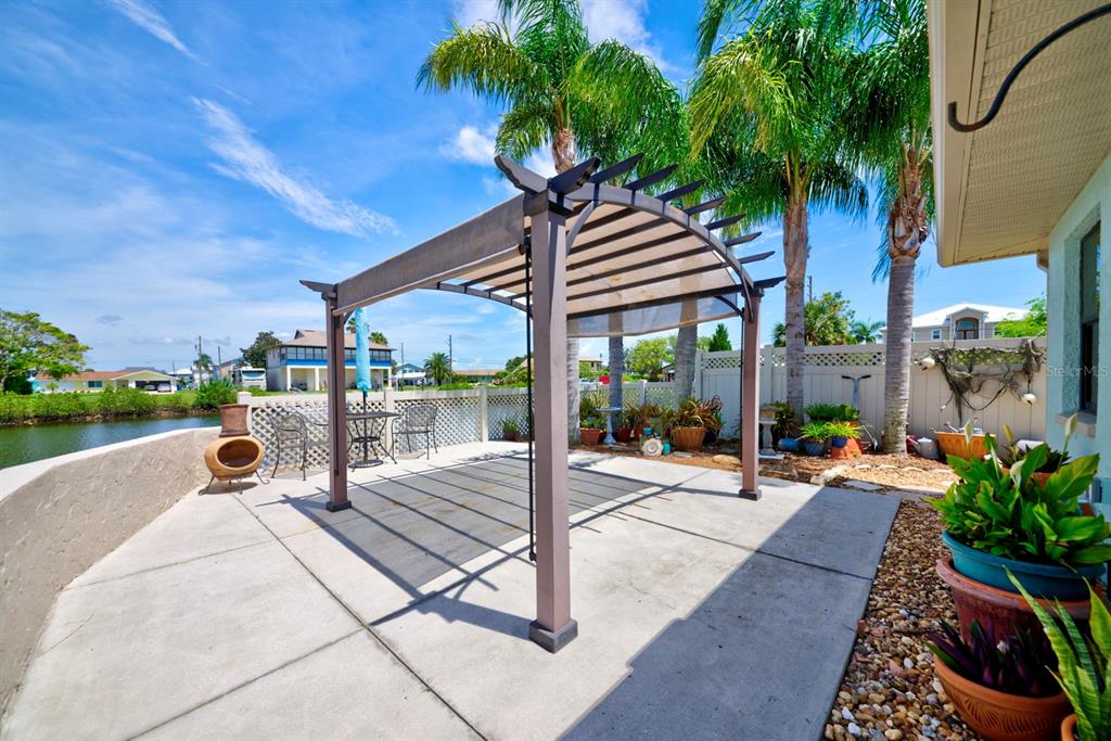 4266 Deleon Drive Hernando Beach, FL 34607 - Photo 48 of 65 a view of a patio with swimming pool table and chairs