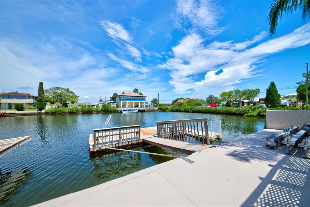 4266 Deleon Drive Hernando Beach, FL 34607 - Photo 57 of 65 a view of a lake with houses in the back