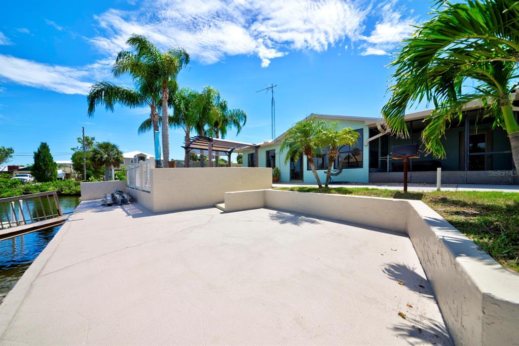 4266 Deleon Drive Hernando Beach, FL 34607 - Photo 59 of 65 a house with palm tree in front of it