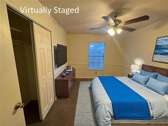 en empty room with windows and fan