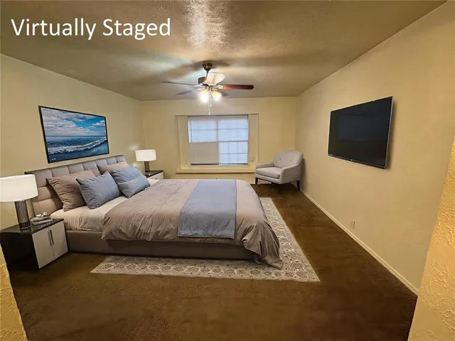 an empty room with a window and a ceiling fan