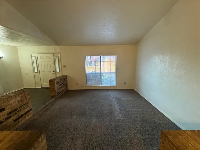 a view of a room with wooden floor and white walls