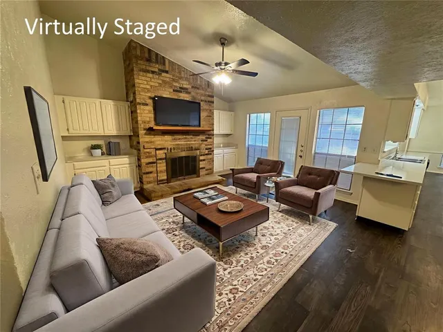 a view of an empty room with a fireplace and a window