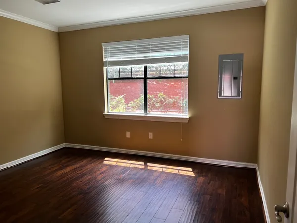 a view of room with window and wooden floor