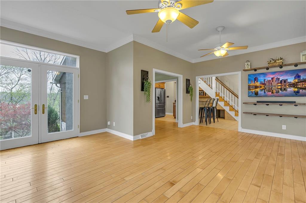 545 6th Avenue Freedom, PA 15042 - Photo 21 of 50 a view of a livingroom with wooden floor and a ceiling fan