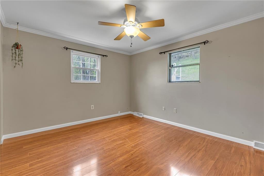 545 6th Avenue Freedom, PA 15042 - Photo 23 of 50 a view of an empty room with wooden floor and a chandelier fan