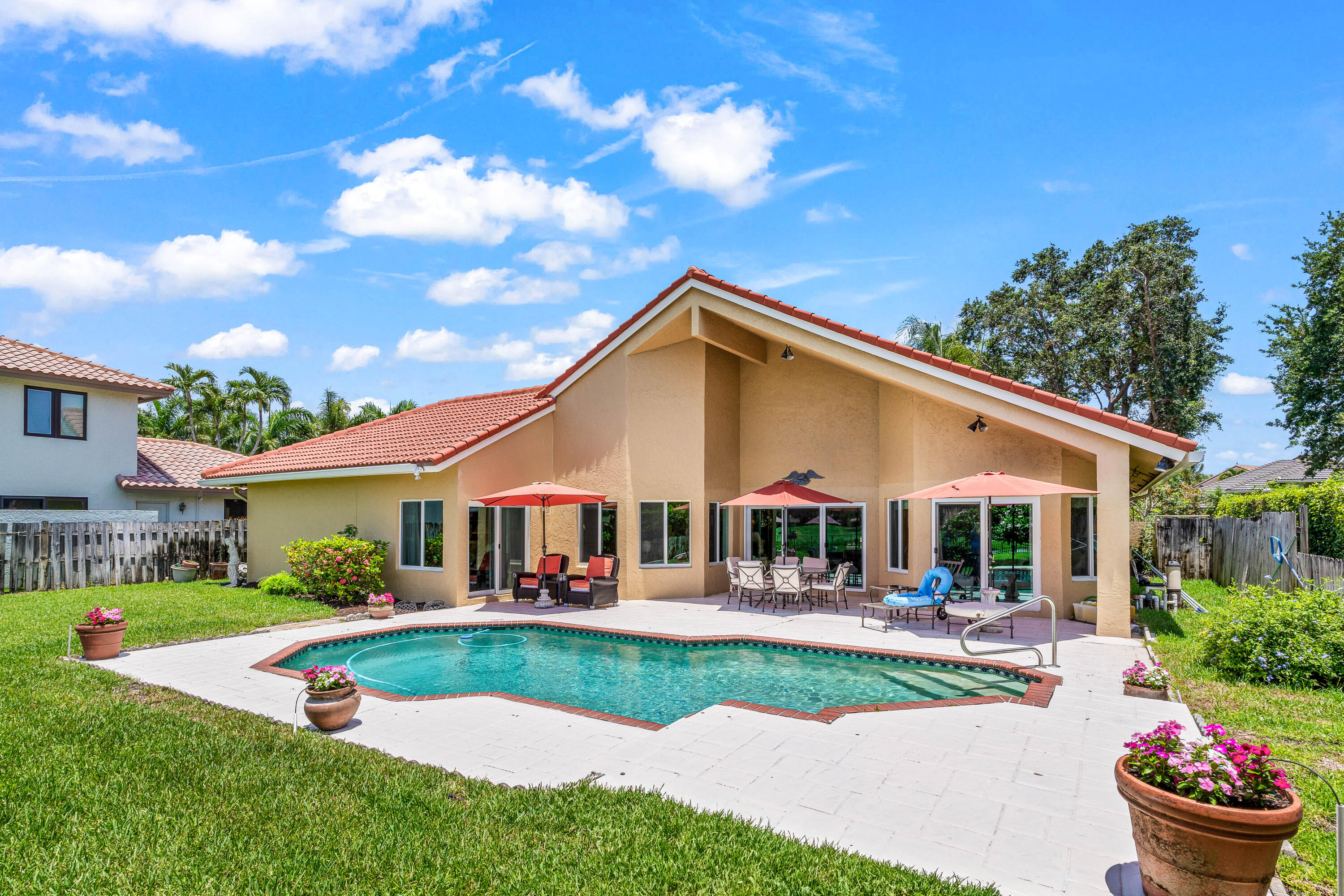 5986 Vista Linda Lane Boca Raton, FL 33433 - Photo 23 of 31 a view of a white house with a big yard and potted plants