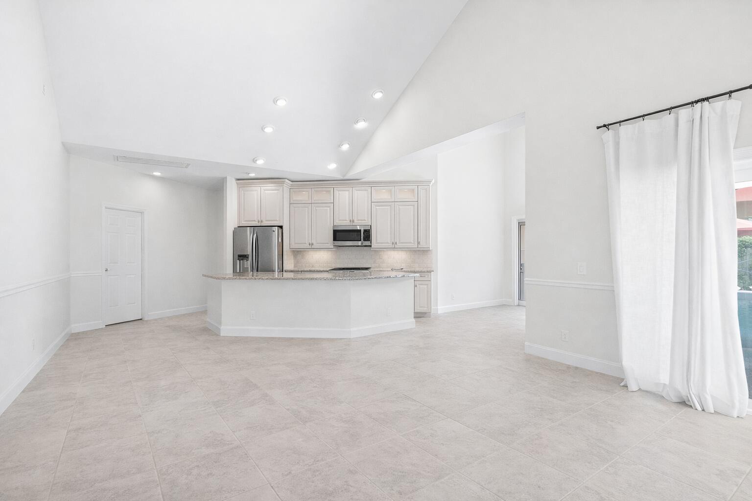 5986 Vista Linda Lane Boca Raton, FL 33433 - Photo 3 of 31 a view of kitchen with refrigerator and white cabinets