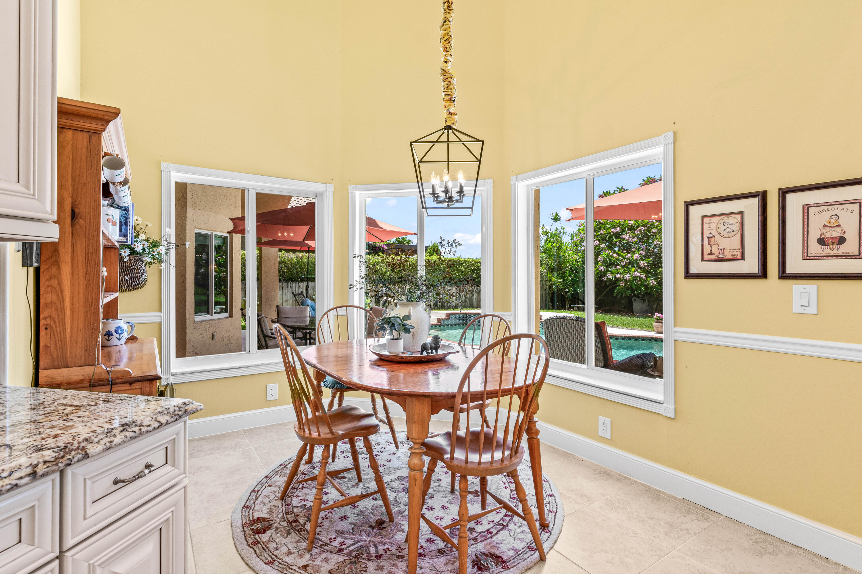 5986 Vista Linda Lane Boca Raton, FL 33433 - Photo 6 of 31 a dining room with furniture a chandelier and wooden floor