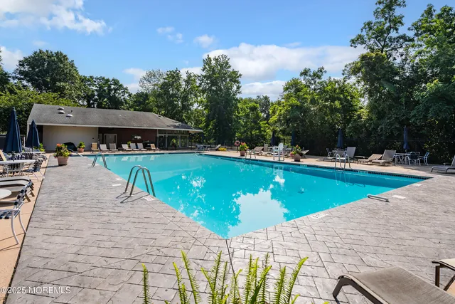 a view of a swimming pool with chairs