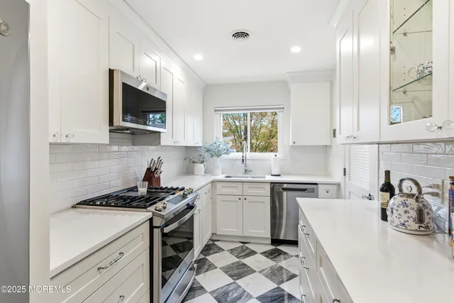 a kitchen with a sink stove and microwave