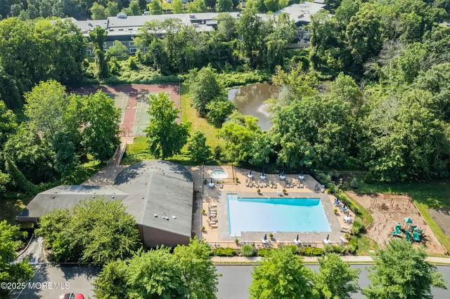 an aerial view of a house with a yard and lake view